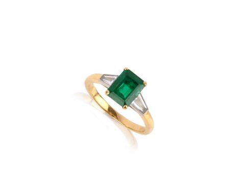 An emerald and diamond three stone ring, the emerald-cut emerald flanked with tapered baguette-shaped diamonds in 18ct gold, 