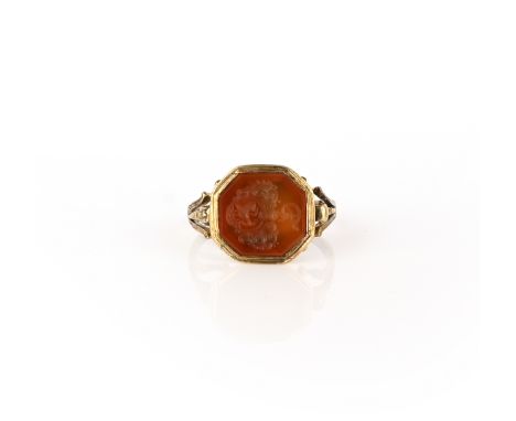 A carnelian intaglio ring, 19th century, set with an octagonal section of carnelian, carved with an intaglio of a coat of arm