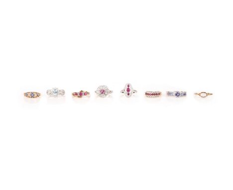 A group of eight gem-set rings, comprising: an early 20th century gold ring set with three sapphires and two cushion-shaped d