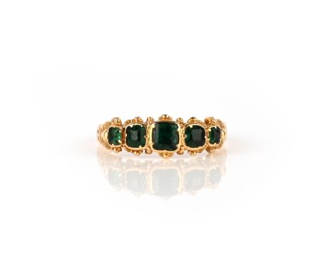 A George III emerald five-stone ring, early 19th century, the five step-cut emeralds in closed-back settings enhanced with be