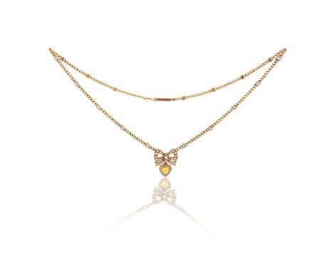 An Edwardian seed pearl-set gold necklace, the seed pearl bow suspending a citrine heart and on a curb-link necklace set with