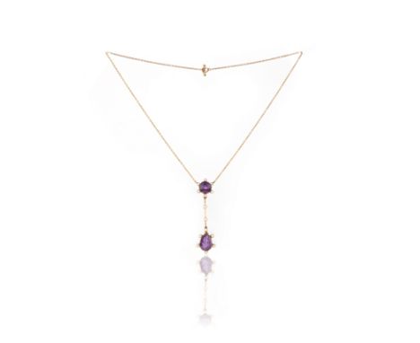 An amethyst and seed pearl pendant, circa 1900, composed of a circular-cut amethyst suspending a pear-shaped amethyst from a 