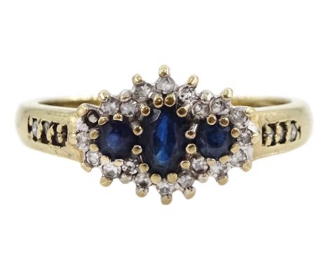 9ct gold three stone sapphire and diamond cluster ring, with diamond set shoulders, hallmarked Condition Report:Approx 3.4gm,