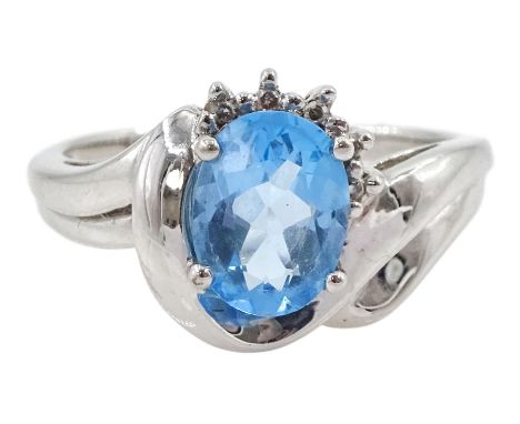 9ct white gold oval blue topaz ring, with five diamond accents, hallmarked Condition Report:Approx 3.1gm, size N-O, well pres