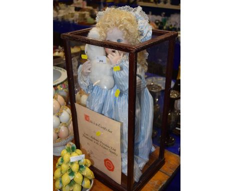 A cased porcelain doll by Susan Langton