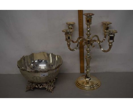 A silver plated bowl on pierced feet together with a silver plated candelabra (2)