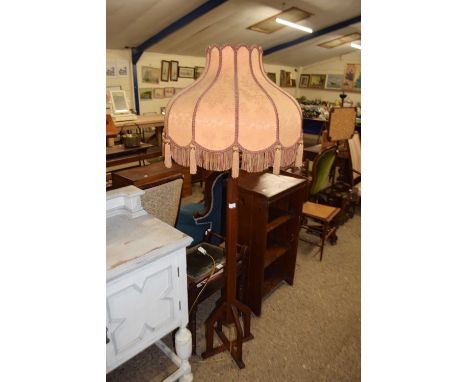 An Art Deco style hardwood standard lamp with shade