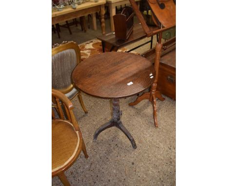 A Georgian oak tilt top wine table on turned column with tripod base
