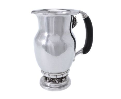 ϒGeorg Jensen, a Danish silver Grape pattern pitcher or jug, post 1945 stamped mark, design no. 407A, with an ebony handle, 2