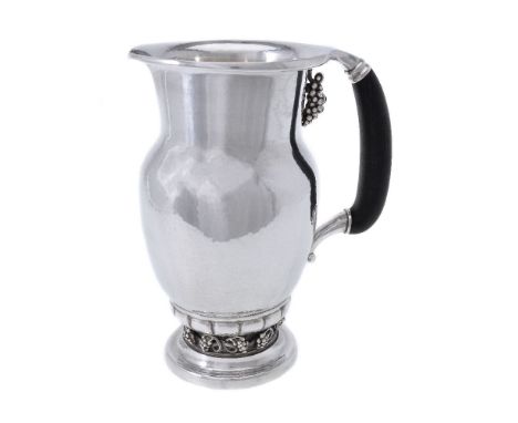 ϒGeorg Jensen, a Danish silver Grape pattern pitcher or jug, post 1945 stamped mark, design no. 407A, with an ebony handle, 2