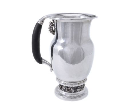 ϒGeorg Jensen, a Danish silver Grape pattern pitcher or jug, post 1945 stamped mark, design no. 407A, with an ebony handle, 2