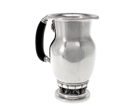 ϒGeorg Jensen, a Danish silver Grape pattern pitcher or jug, post 1945 stamped mark, design no. 407A, with an ebony handle, 2