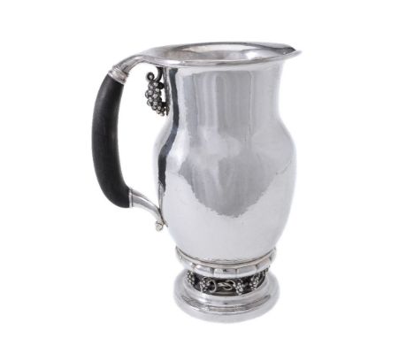 Georg Jensen, a Danish silver Grape pattern pitcher or jug, post 1945 stamped mark, design no. 407A, with an ebony handle, 23