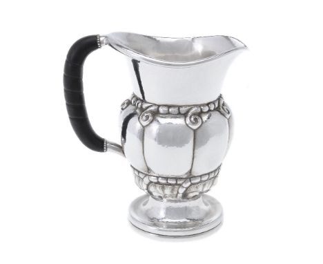 ϒGeorg Jensen, a Danish silver water jug or pitcher, post 1945 stamped marks, design no. 7, with an ebony handle, 20cm (8in) 