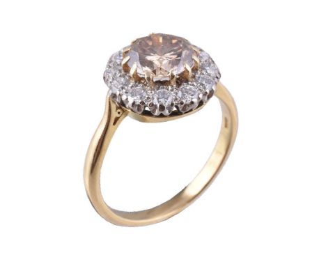 A diamond and cinnamon diamond cluster ring, the brilliant cut cinnamon diamond weighing 1.75 carats, within a surround of br