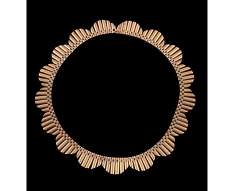 An 18 carat gold collar necklace by John Grinsell &amp; Sons for Garrard &amp; Co Ltd., the graduated lobed fringe to a conce