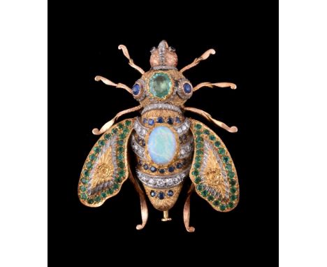 A multi gem set bee brooch, the head with red stone eyes, the thorax set with an oval cut emerald, between two circular caboc