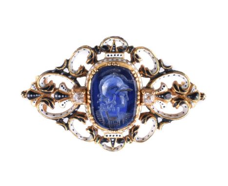 An 1870s sapphire intaglio brooch by Carlo Giuiliano, the central intaglio carved with the profile of Athena, between two min