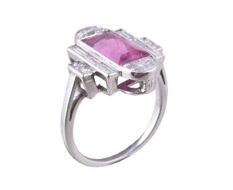 A pink tourmaline and diamond dress ring, the rectangular cut pink tourmaline collet set within a surround of fancy cut, bagu