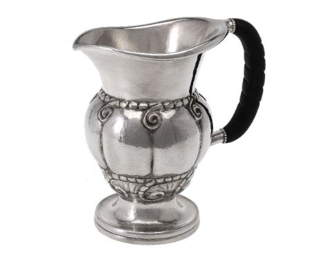 ϒGeorg Jensen, a Danish silver water jug or pitcher, post 1945 stamped marks, design no. 7, with an ebony handle, 20cm (8in) 