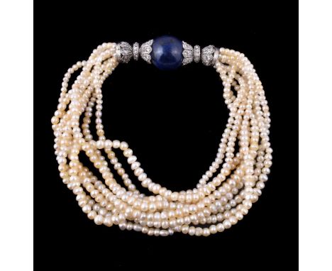 A pearl, lapis lazuli and diamond bracelet, the multi strand pearl bracelet to a polished lapis lazuli orb between rose cut d