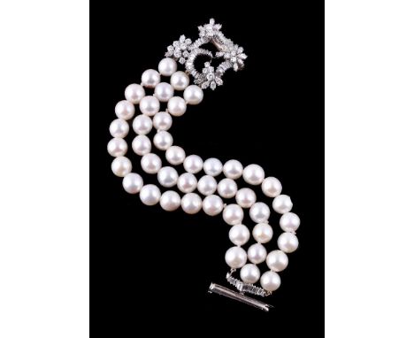 A cultured pearl and diamond bracelet, the three rows of 10mm cultured pearls, to the openwork cluster clasp set with brillia
