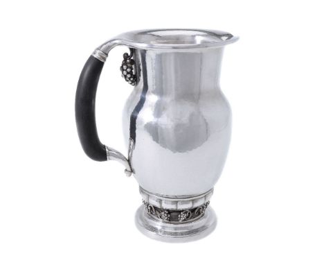 ϒGeorg Jensen, a Danish silver Grape pattern pitcher or jug, post 1945 stamped mark, design no. 407A, with an ebony handle, 2