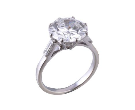 A diamond ring, the brilliant cut diamond weighing 3.23 carats, in an eight claw setting, to baguette cut diamond set shoulde