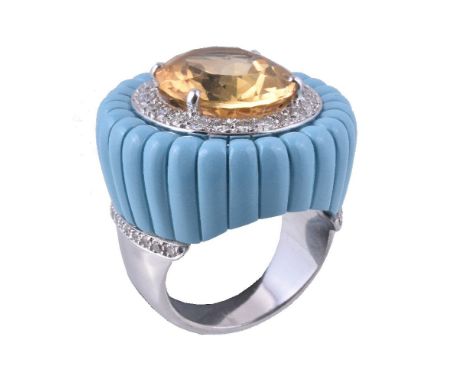 A citrine, turquoise and diamond dress ring, the central oval cut citrine claw set within a surround of brilliant cut diamond