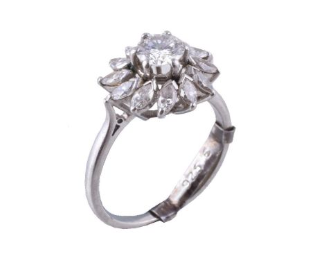 A diamond cluster ring, the central brilliant cut diamond, estimated to weigh 0.70 carats, claw set within a surround of marq