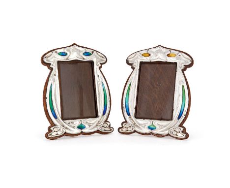 A matched pair of Arts and Crafts silver and enamel photograph frames by Charles S. Green &amp; Co., Birmingham 1904 and 1905