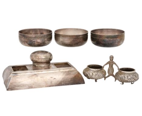 A South East Asian silver repoussé double salt cellar, c1900, 12cm l, indistinctly marked and a silver inkstand, 7oz 10dwt an