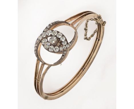 A diamond bangle, c1900, with old cut diamonds, the two entwined crescents demountable for wear as a brooch, in gold, 55mm w 