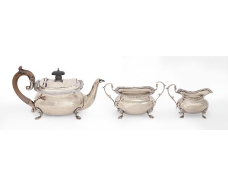 An Edwardian silver gadrooned oblong bachelor's tea service, on paw feet, teapot 11cm h, by Edward Barnard &amp; Sons Ltd, Lo