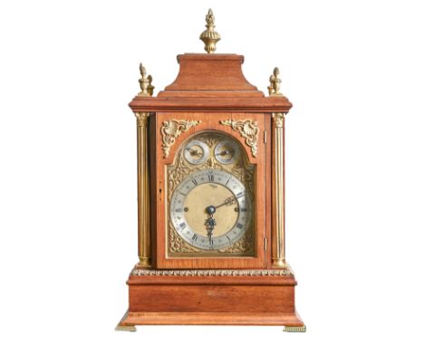 An Edwardian eight-day brass mounted oak bracket clock, the breakarched brass dial with matted centre, silvered chapter ring 