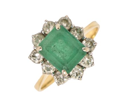 An emerald and diamond ring, the step cut emerald 7 x 9mm, in evenly sized diamond surround, in white gold on gold hoop, 4.8g