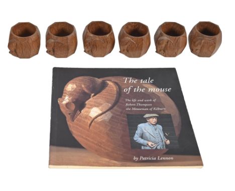A set of six Robert 'Mouseman' Thompson oak napkin rings, c1980, of octagonal shaped, carved mouse 'signature' and Lennon (Pa