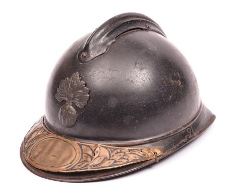 A WWI French Army Adrian steel helmet, grenade badge, and commemorative brass plate fixed to front peak. GC (brass plate badl