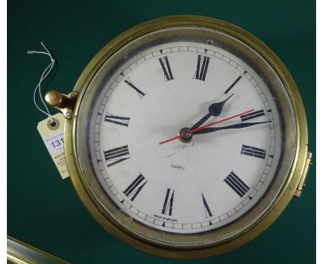 A brass cased ship’s clock, white face, 8" diameter of case. GC (not known if working) £20-25.