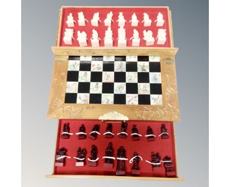 A Chinese style folding chess board with pieces 
