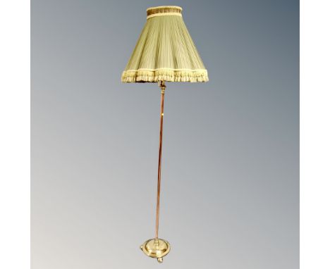 An antique brass and copper standard lamp with shade 