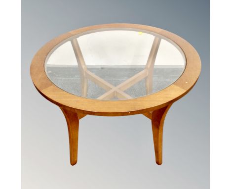 A 20th century teak circular lamp table with glass inset panel 