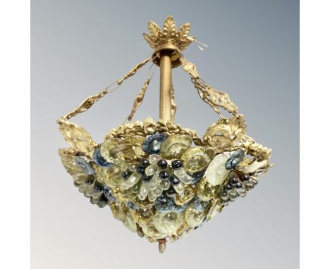 A vintage brass light fitting decorated with grapes and flowers 
