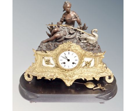 A 19th century gilt-brass and spelter mantel clock surmounted by female figure with swan on wooden stand, pendulum and key  C