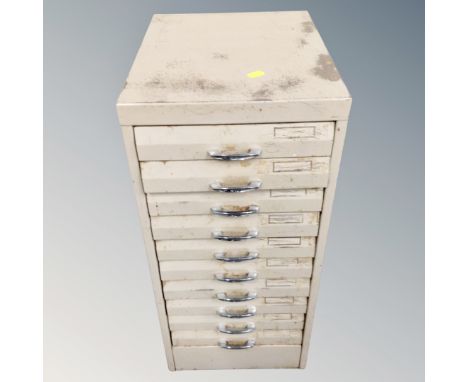 A metal ten drawer filing chest containing hand tools and hard ware 