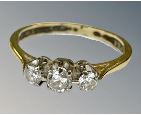 An 18ct gold three stone diamond ring, size L.