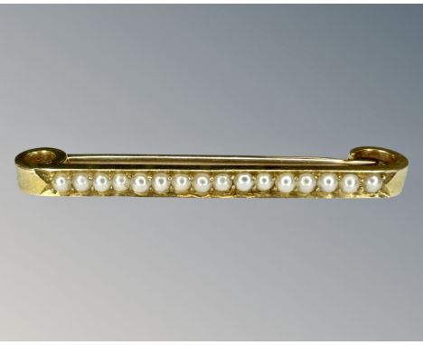 A 15ct gold pearl set bar brooch, width 4.5 cm.