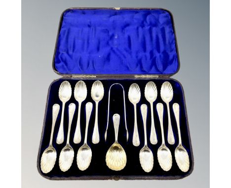 A Victorian cased set of twelve silver spoons, tongs and matching caddy spoon. 