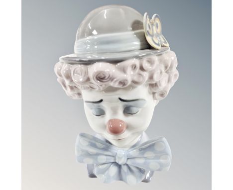 A Lladro bust of a clown no. 5611 together with a further Nao clown on wooden stand (2)