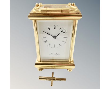 A brass eleven jewel carriage clock with key 
